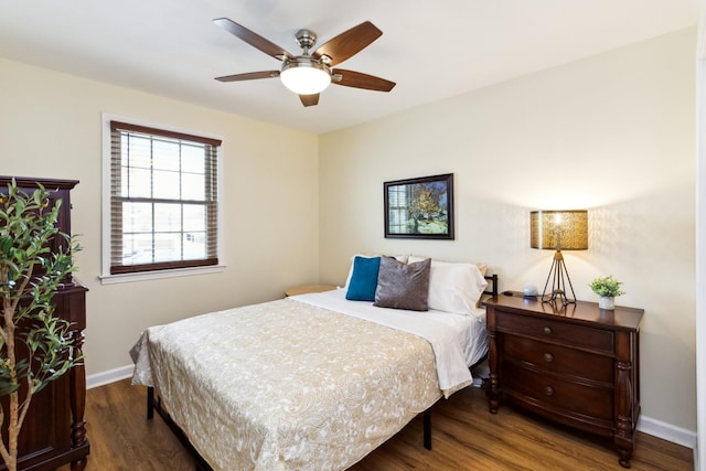 bedroom featuring ceiling fan, baseboards, and wood finished floors