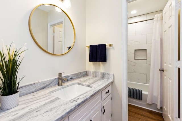 bathroom featuring shower / tub combo with curtain, visible vents, wood finished floors, and vanity