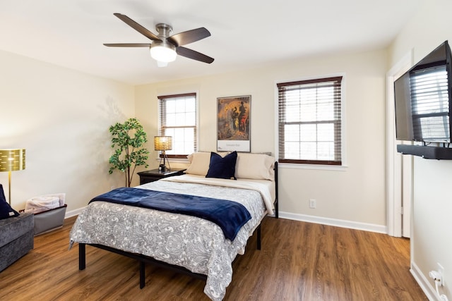 bedroom featuring ceiling fan, baseboards, and wood finished floors