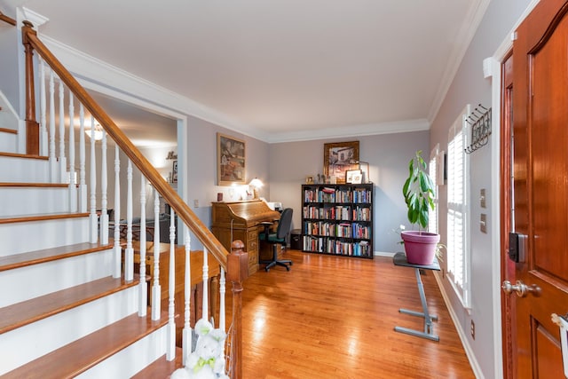 office area featuring crown molding, baseboards, and wood finished floors