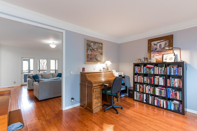 office area featuring baseboards, wood finished floors, and crown molding