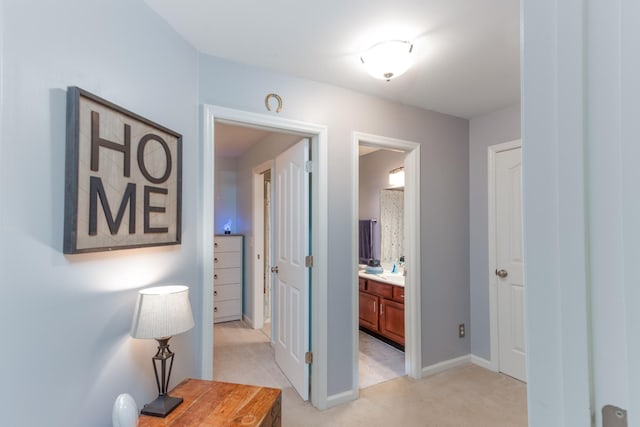 hall with light carpet and baseboards