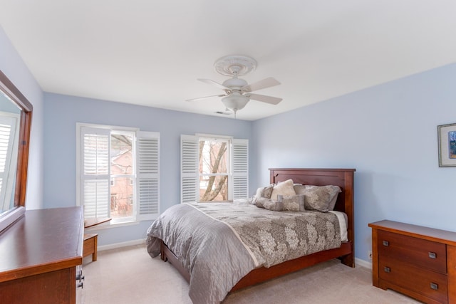 bedroom with baseboards, a ceiling fan, and light colored carpet