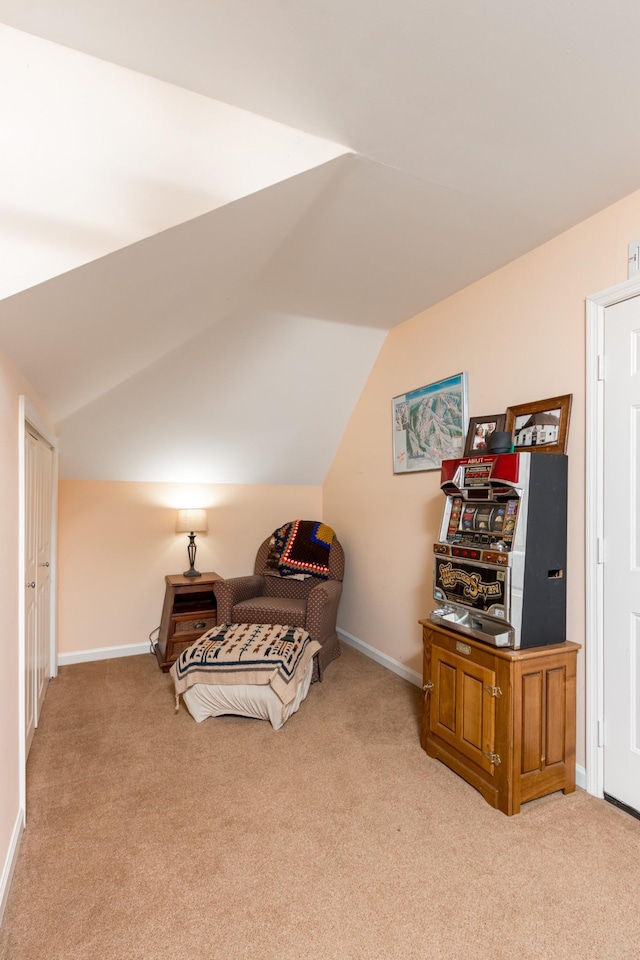 bedroom featuring lofted ceiling, baseboards, and carpet flooring