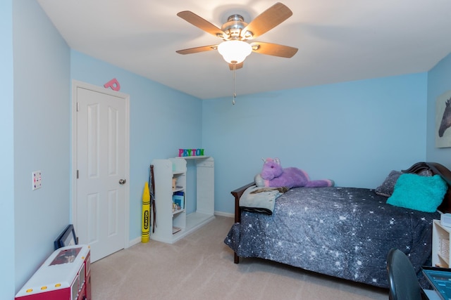 carpeted bedroom featuring ceiling fan and baseboards