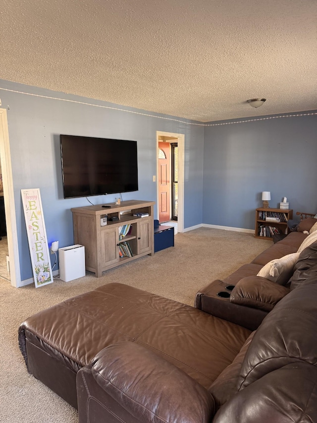 carpeted living room featuring baseboards and a textured ceiling