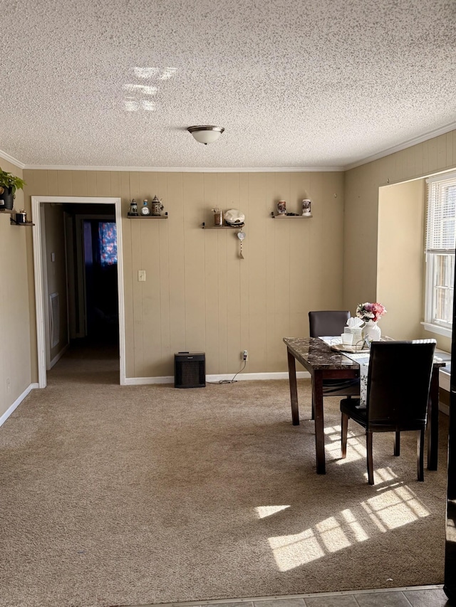 unfurnished office with baseboards, carpet, ornamental molding, and a textured ceiling