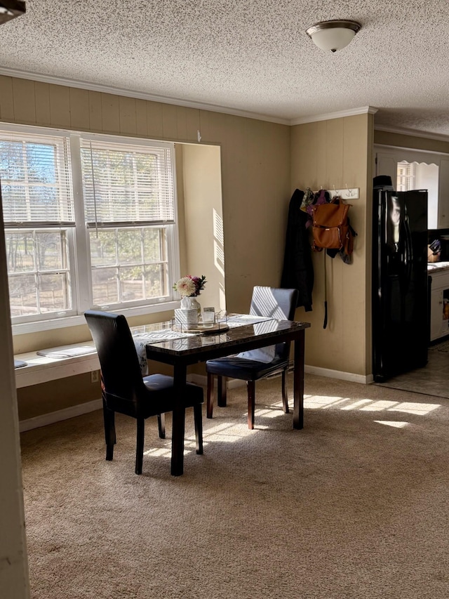 dining room with light carpet, a textured ceiling, and crown molding