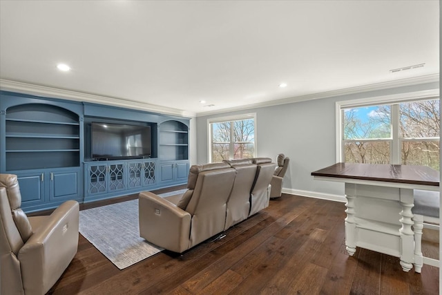 living area with built in shelves, baseboards, dark wood finished floors, and crown molding