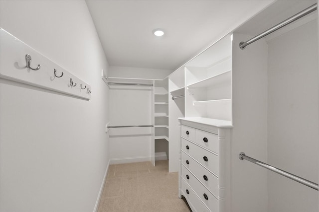 walk in closet with light colored carpet