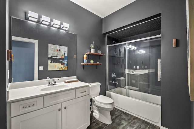 bathroom featuring enclosed tub / shower combo, vanity, and toilet