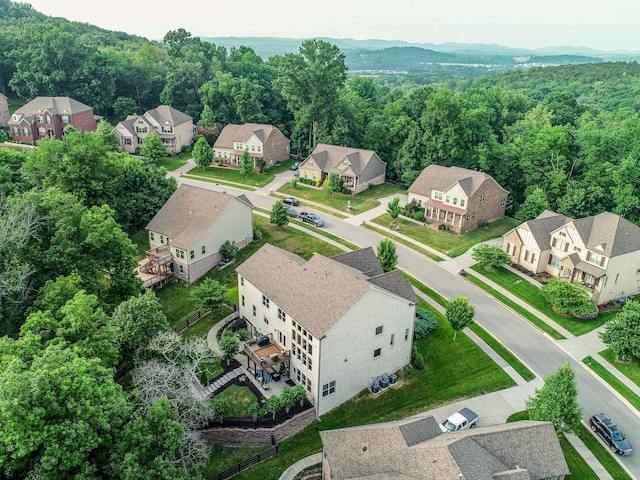 bird's eye view featuring a forest view and a residential view