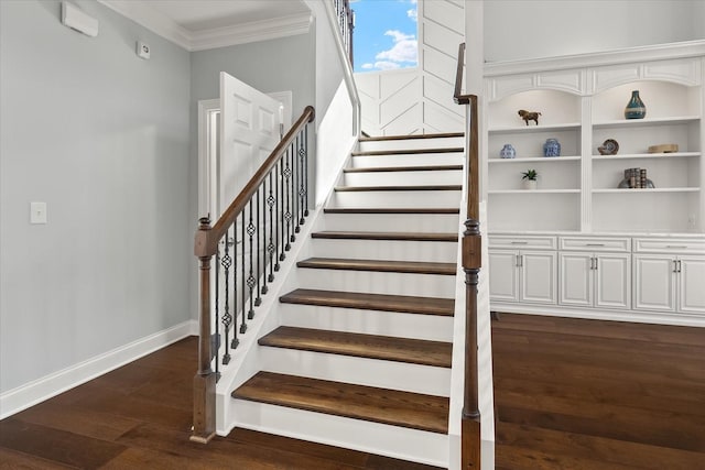 stairs with baseboards, crown molding, and wood finished floors