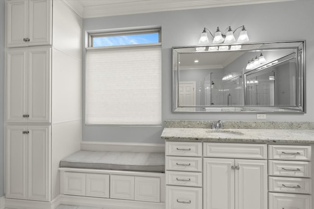 full bath featuring a stall shower, vanity, and crown molding