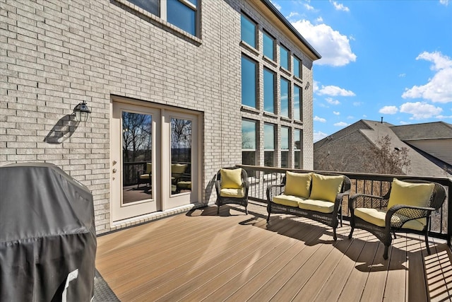 wooden terrace featuring grilling area and an outdoor hangout area