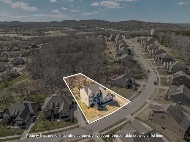 drone / aerial view featuring a residential view and a mountain view