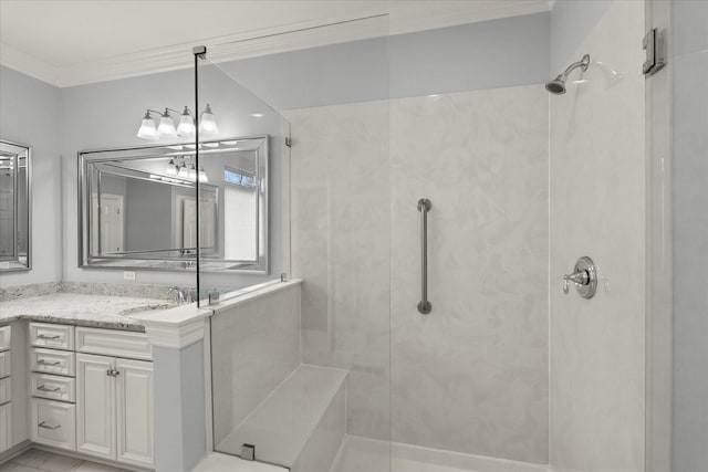 bathroom featuring tiled shower, crown molding, and vanity