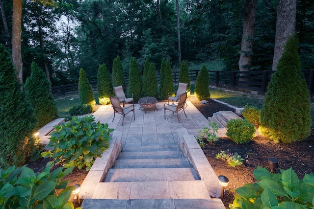 view of patio / terrace featuring fence and a fire pit