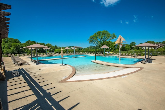 pool featuring a patio area and fence