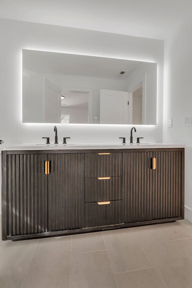 bathroom with visible vents, a sink, and tile patterned floors