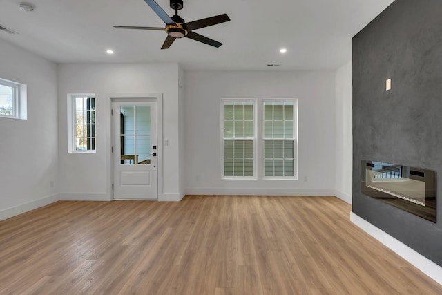 interior space with light wood finished floors, recessed lighting, and baseboards