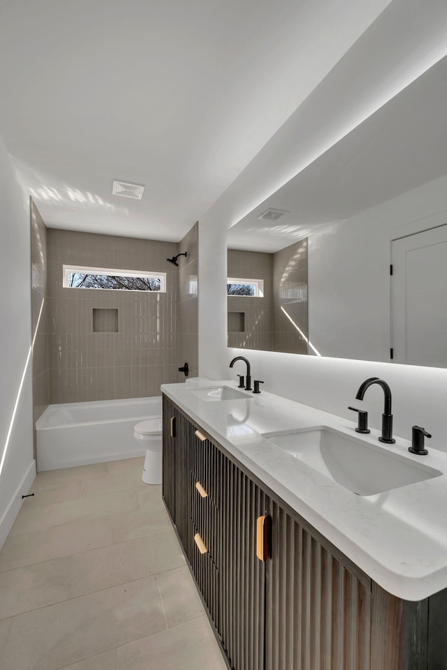 bathroom featuring toilet, visible vents, and a sink