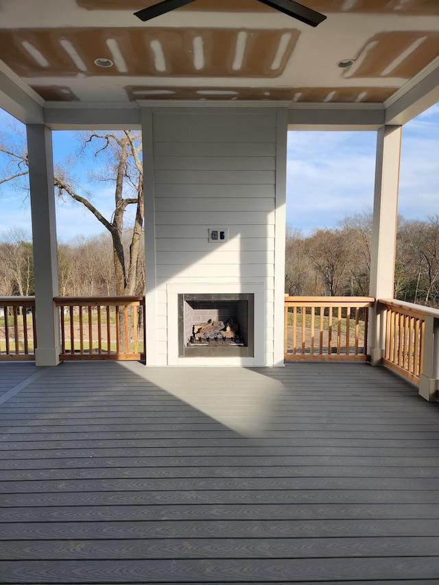 wooden deck with a large fireplace