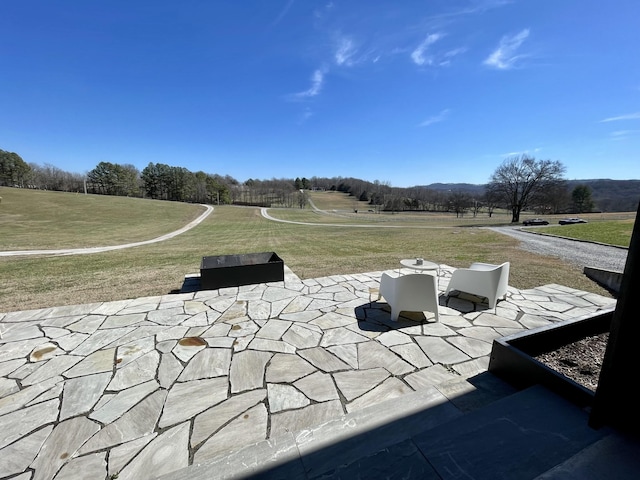 view of home's community with a lawn and a patio area