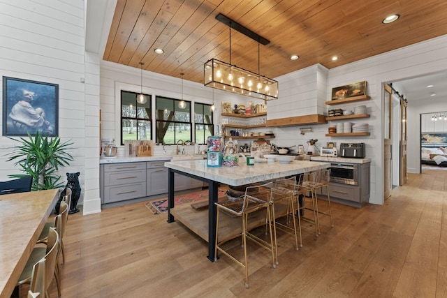 kitchen with wooden ceiling, light wood-style flooring, pendant lighting, gray cabinets, and open shelves