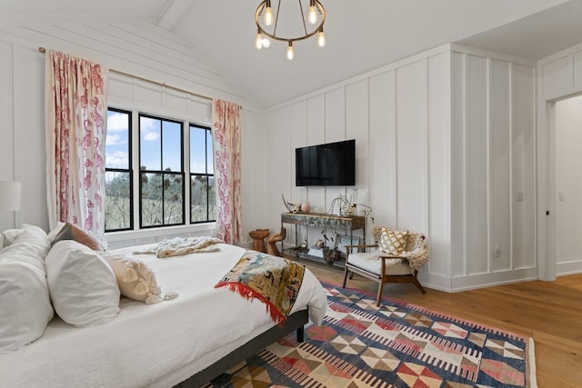 bedroom featuring vaulted ceiling with beams, a chandelier, and wood finished floors