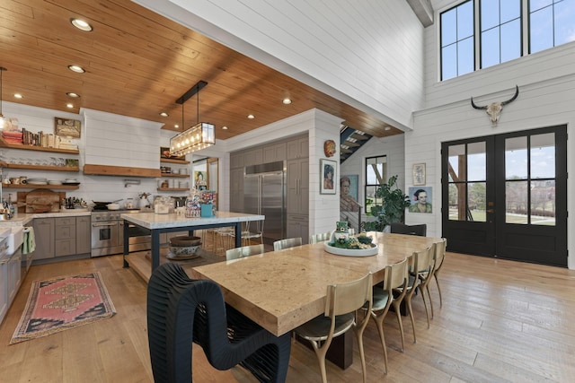 dining room with recessed lighting, wooden ceiling, light wood-style flooring, and french doors