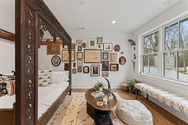 interior space with a healthy amount of sunlight, visible vents, and wood finished floors