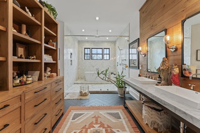 bathroom with a walk in shower, double vanity, a sink, and recessed lighting