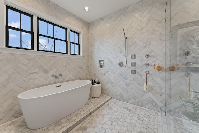 bathroom with a freestanding tub and a tile shower