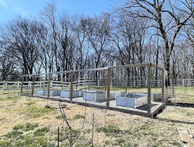 view of yard with a vegetable garden and fence