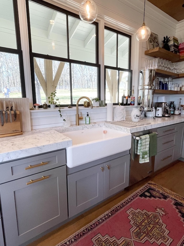 bar featuring decorative light fixtures, a sink, beam ceiling, crown molding, and stainless steel dishwasher