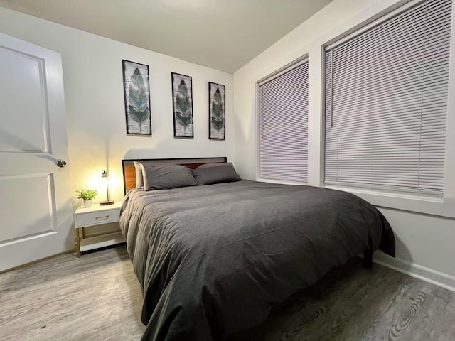 bedroom with baseboards and light wood-style floors