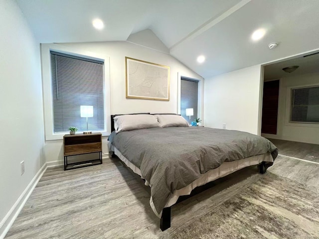 bedroom featuring lofted ceiling, recessed lighting, baseboards, and wood finished floors