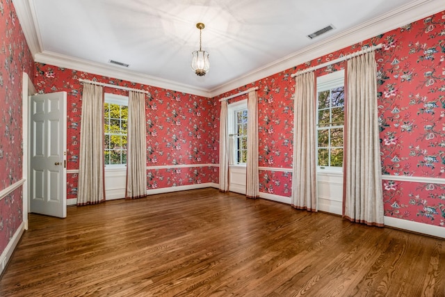 unfurnished room with wood finished floors, visible vents, baseboards, and wallpapered walls