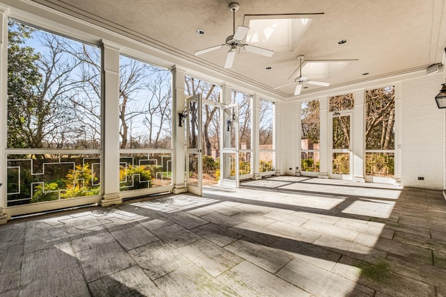 unfurnished sunroom featuring a skylight and ceiling fan