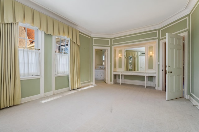 interior space with light carpet, baseboards, and crown molding