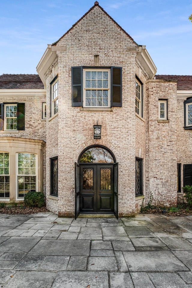 view of exterior entry with brick siding