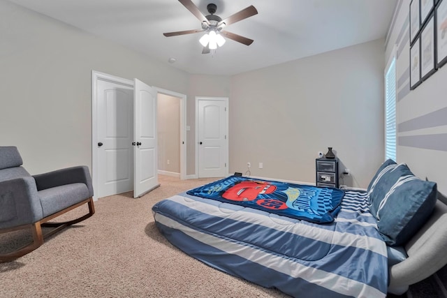 carpeted bedroom with ceiling fan and baseboards