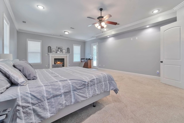 carpeted bedroom featuring recessed lighting, a ceiling fan, baseboards, a tiled fireplace, and crown molding