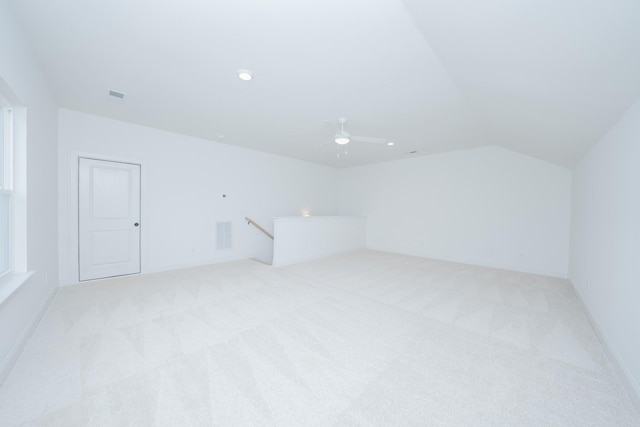 bonus room featuring a ceiling fan, light colored carpet, vaulted ceiling, and visible vents