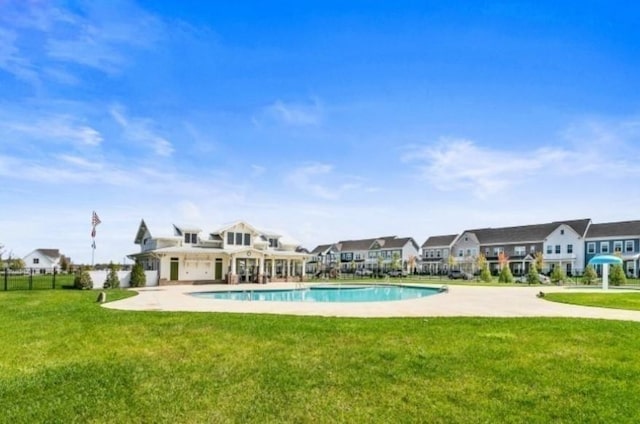 view of pool with a fenced in pool, a yard, a patio, fence, and a residential view