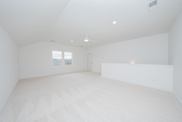 bonus room with ceiling fan, light colored carpet, visible vents, baseboards, and vaulted ceiling