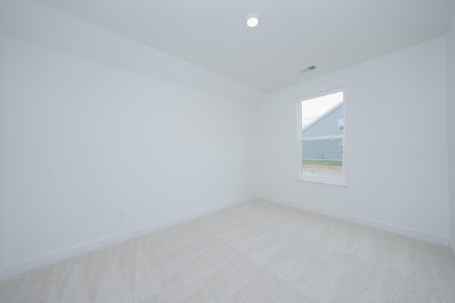 empty room with recessed lighting, light carpet, visible vents, and baseboards