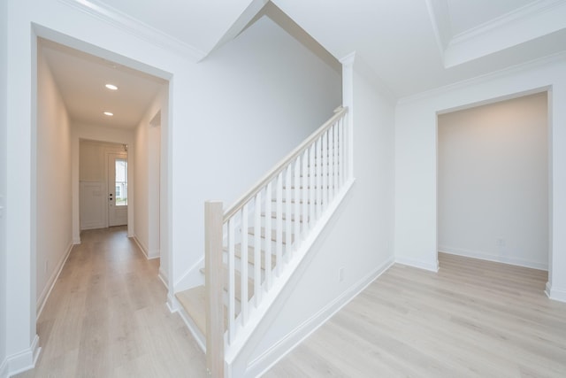 staircase featuring baseboards, ornamental molding, wood finished floors, and recessed lighting