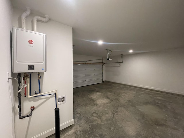 garage with baseboards, tankless water heater, and a garage door opener